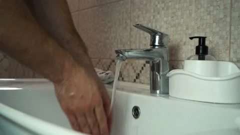 A man washes his hands with soap and a towel Video stock 143635177