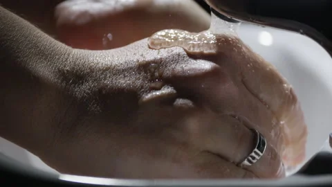 Man washes his hands with soap under the tap, close-up, black background. Stock-Footage 210203680