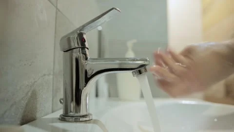 A man washes his hands with soap under a tap of water. Hand hygiene against Stock-Footage 243161546