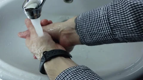Man washes his hands thoroughly with soap in a bathroom. Stock-Footage 130651213