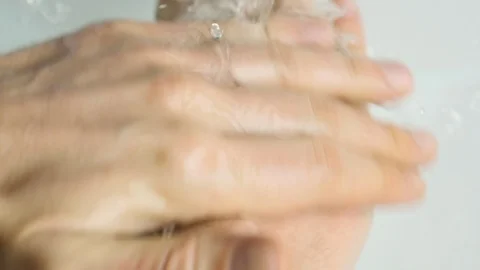 A man washes his hands under the faucet in the bathroom. Stock Footage 102304109