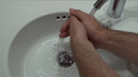 Man washes his hands under water tap Stock Footage 117921801