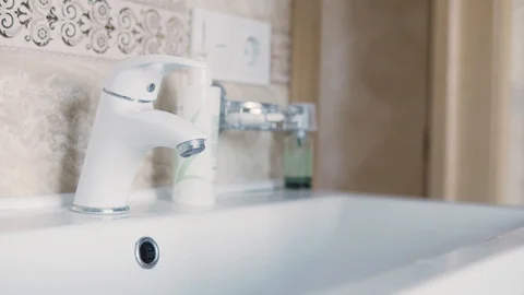 A man washes his hands under the tap in the morning after waking up close up Stock Footage 126719611