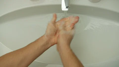A man washes his hands under the tap with soap Stock Footage 129615213