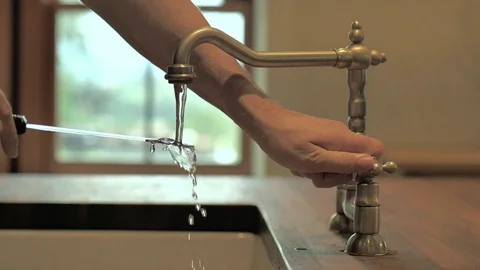 Man washes a knife Stock Footage 116902202