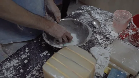 A man washes a metal plate in the workshop Stock Footage 102258426