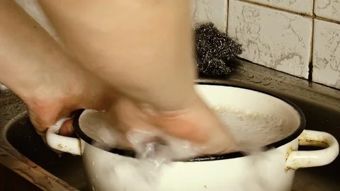 Man washes the pan Stock Footage 78304204