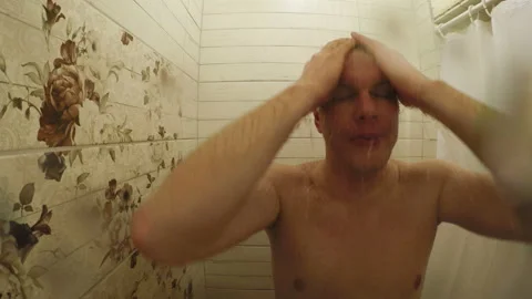 A man washes in the shower Stock Footage 106957175