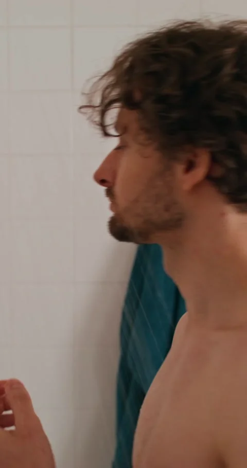 A man washes in the shower 스톡 동영상 287822095