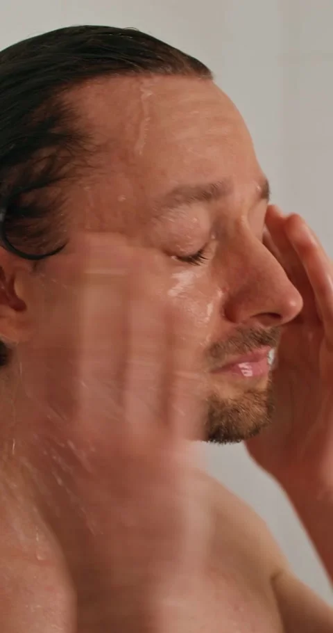 A man washes in the shower 스톡 동영상 287822143