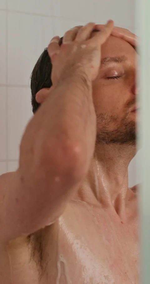 A man washes in the shower 스톡 동영상 287822407