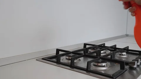 A man washes the stove in the kitchen Stock Footage 127834798