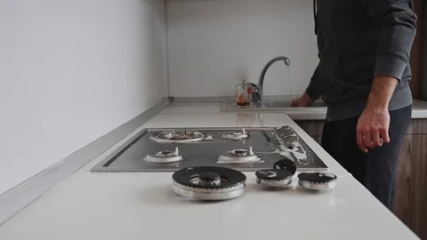 A man washes the stove in the kitchen Stock Footage 127834842
