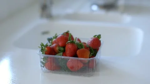 Man washes strawberries Stock Footage 22063528