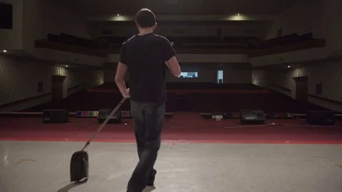 Man washes theater stage using a mop Stock Footage 71766912