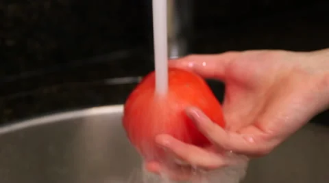 Man washes tomato in sink close up Stock-Footage 61353311