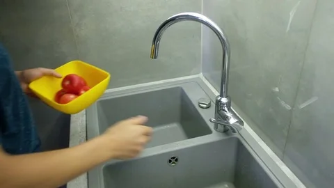 Man washes tomatoes Stock Footage 82307971