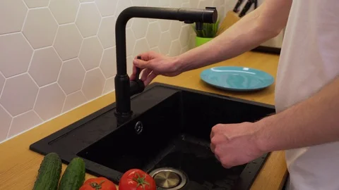 A man washes under running water the tomatoes Stock Footage 129054478