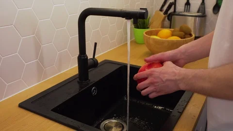 A man washes under running water grenades Stock Footage 129054482