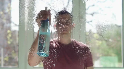 A man washes the windows in the office Stock Footage 107550588