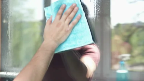 A man washes the windows under the order in the mall Stock Footage 107550811