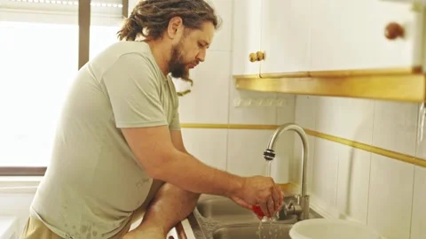Man washing and preparing vegetables in kitchen Stock Footage 307993541