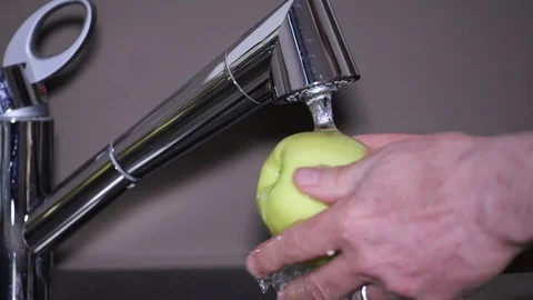 Man washing an apple Video stock 128876268