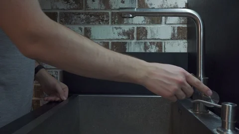 Man washing a cup with a sponge Stock Footage 102222947