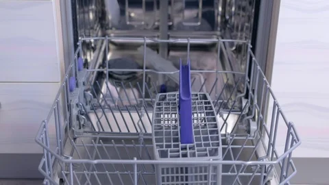 Man washing dishes loading dishwasher putting tableware and kitchenware basket. Stock Footage 116373635