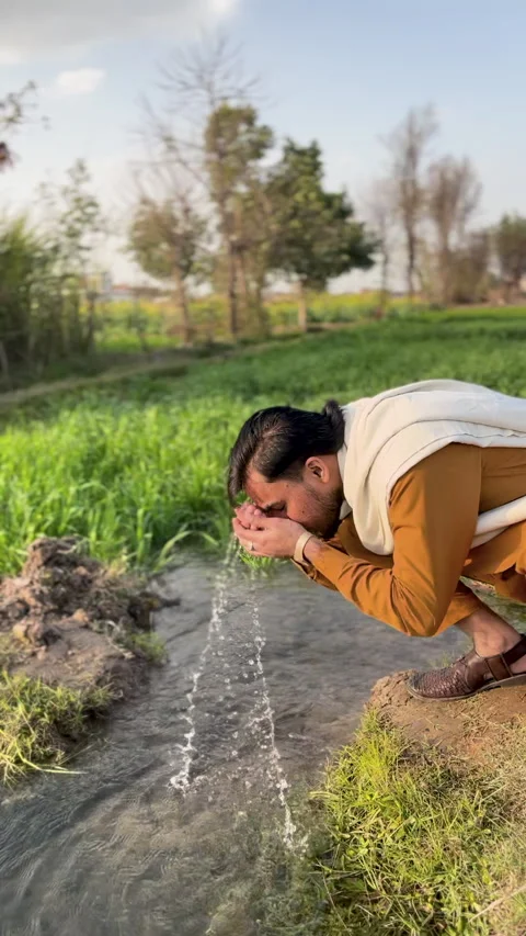 Man Washing Face in Stream Stock Footage 334485361