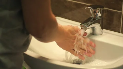 Man washing hands In bathroom Stock Footage 138467963