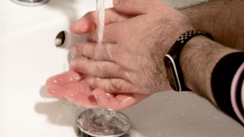 Man is washing hands in bathroom to remove dirt Stock Footage 191044847