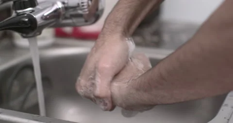 Man washing hands in sink creating soapy bubbles 動画素材 130670134