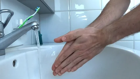 Man washing hands with soap in the bathroom sink Stock Footage 127100673