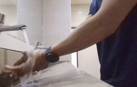 Man Washing Hands with Soap in Public Restroom Stock Footage 327770557
