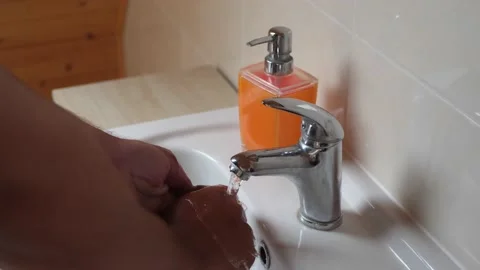 Man washing hands without using soap Stock Footage 208956283