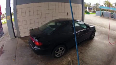A man washing his car timelapse Stock Footage