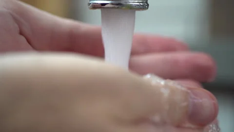 Man washing his hands in kitchen, Slow motion macro Stock Footage 140216533
