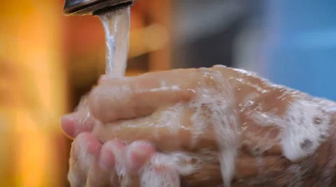 A man washing his hands throughly with soap and water - pan down Stock Footage 67401136