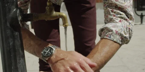 Man washing his hands under a tap Stock Footage 58857761