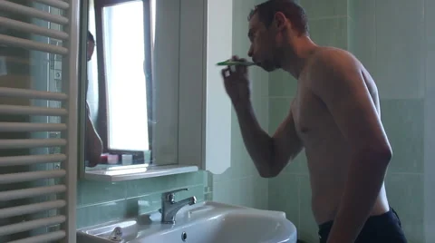 Man washing his teeth Stock Footage 55533453