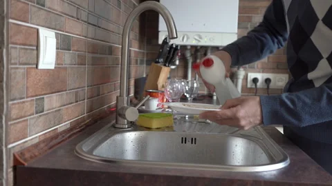 Man washing a plate Stock Footage 300372701