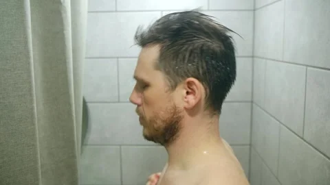 Man washing in shower slow motion Stock Footage 312985083