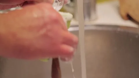 Man Washing Spoon With Sponge At Kitchen Sink During Daily Household Cleaning Stock Footage 341393855