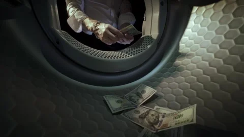 Man Washing US Dollar Banknotes in Washing Machine slow motion. Money Laundering Stock Footage 340170986