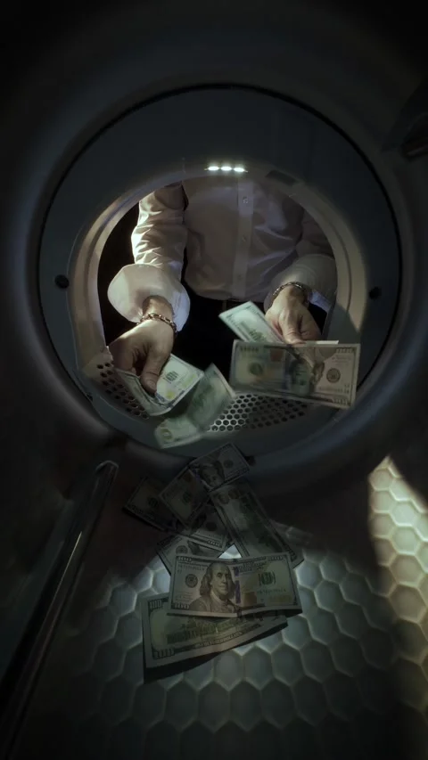 Man Washing US Dollar Banknotes in Washing Machine slow motion. Money Laundering Stock Footage 340171081