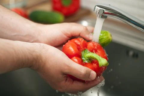 Man washing vegetables Stock Photos