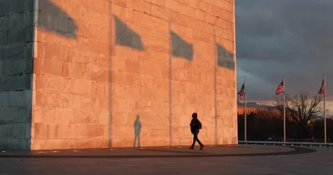 A man at the Washington Monument at sunset Stock Footage 148107383