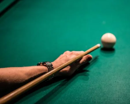 Man with watch playing pool Stock Photos