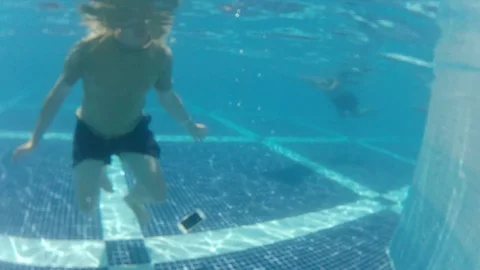 Man watch smartphone but accidentally drop it under water at pool bottom Video stock 81359101